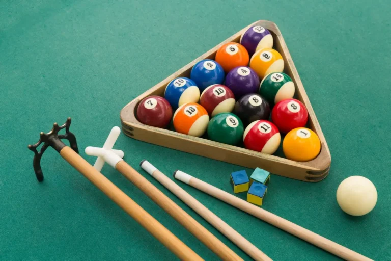 Billiard table with balls and cue stick ready for the game